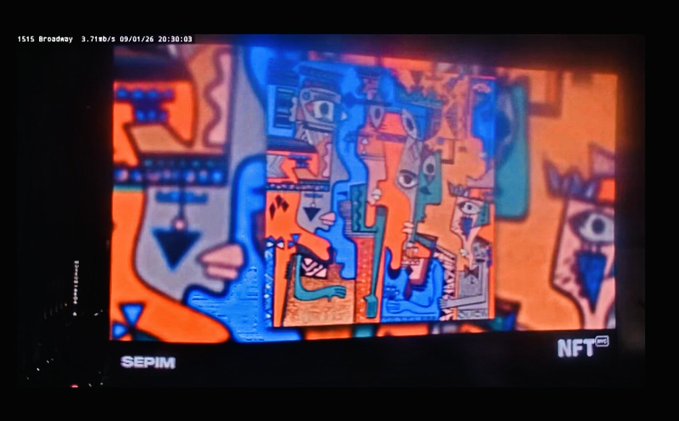 A digital screen displaying colorful abstract artwork with the text 'SEPIM' in the bottom left and 'NFT' in the bottom right, along with a timestamp '1515 Broadway 3.71b/s 09/01/26 20:30:03' at the top.