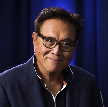 A portrait of Robert Kiyosaki, author of "Rich Dad Poor Dad," wearing black-rimmed glasses and a dark blazer against a blue backdrop, accompanying a post about his bullish prediction that Ethereum ($ETH) would reach $60,000 by 2026.