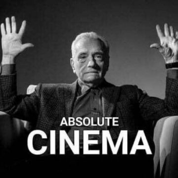 A black-and-white photo shows an older man with a mustache in a suit and tie, seated with both hands raised palms-out in an expressive gesture, with bold white text reading "ABSOLUTE CINEMA" overlaid across the bottom. The meme references "$cinema," a cryptocurrency token being promoted on social media, where the phrase "absolute cinema" is used as ironic internet slang to praise something as extraordinarily impressive. The post highlights the token's price action relative to $pair and frames $cinema as a leading "dragon head" in the meme coin ecosystem.