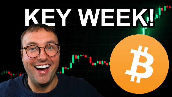 A smiling man with glasses in front of a candlestick chart, with bold text reading 'KEY WEEK!' and a Bitcoin (BTC) logo.