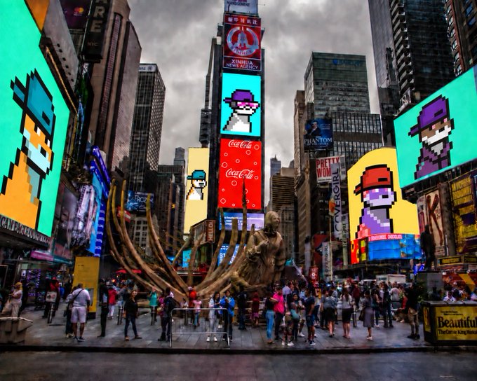 A Times Square scene featuring large digital billboards displaying pixel art characters resembling CryptoPunk-style NFTs, with Coca-Cola, Xinhua, and other advertisements visible amid crowds of people.