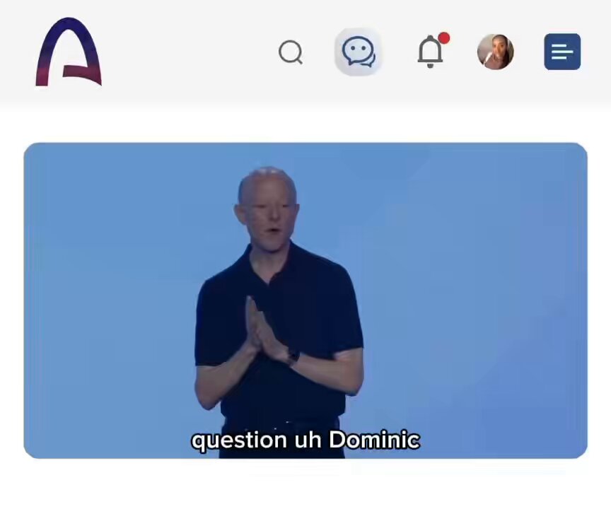 The image shows a man standing in front of a computer screen with a question displayed on the screen. The text on the screen reads "Question u h dominic", which seems to be related to the topic of blockchain technology or infrastructure. The image also includes a caption that says, "If you're going to serve a million people, you need the infrastructure to scale. You need a blockchain network built to support it through the most demanding architectures." This suggests that the man might be discussing the importance of having a robust and scalable infrastructure for blockchain applications or projects.