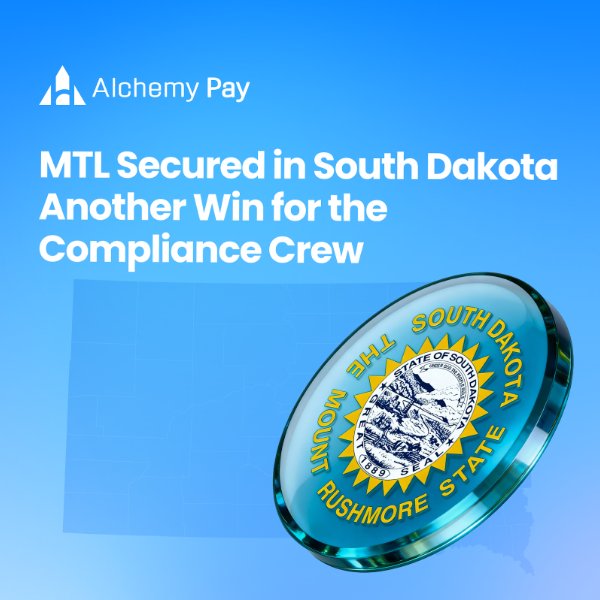 The image features a blue glass coin with a yellow sun design on top, placed against a light blue background. The text at the bottom of the image reads "MTL Secured in South Dakota Another Win for the Compliance Crew".