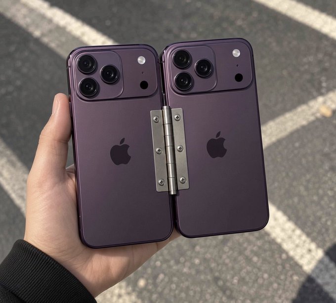 A hand holds two purple iPhones connected by a metal hinge, creating a custom folding device.
