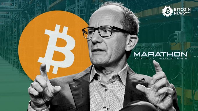 A man with glasses gestures while speaking, with a large Bitcoin logo and 'MARATHON DIGITAL HOLDINGS' branding in the background, alongside a 'BITCOIN NEWS' watermark.