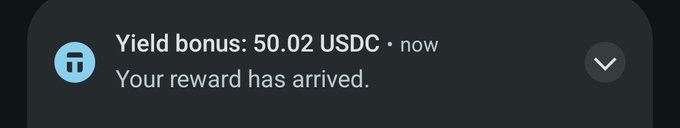 A mobile notification on a dark background from a crypto application, displaying 'Yield bonus: 50.02 USDC • now' and 'Your reward has arrived.' next to a blue app icon.