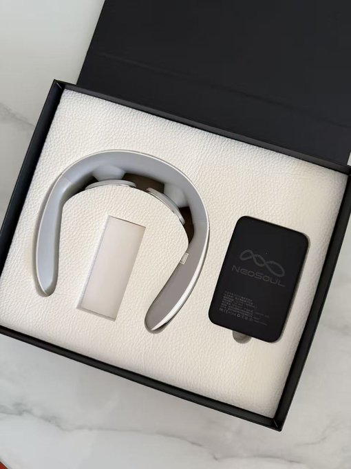Premium black gift box containing a silver U-shaped neck massager branded 'Nageoul' with its portable charging unit displayed on white textured padding.