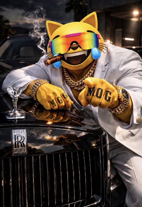 This picture features a man dressed in expensive clothing and jewelry vacationing in a luxury car. The man's image has been photoshopped to show a cat face, which appears to be referencing the viral internet call "Mog". This also compliments the caption, as the man has the M renderings on his knuckles. Thus, this picture appears to be a fun display of extravagance by a crypto stakeholder, showing how much their needs dwarf the pitiful 'mog' they hold of the currency.