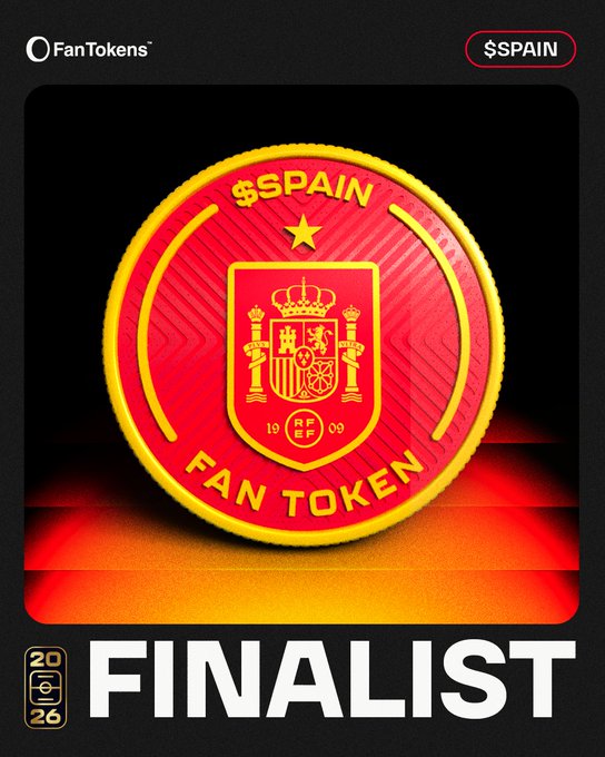 A vibrant red and gold $SPAIN Fan Token commemorative coin from FanTokens™ is displayed, featuring the Spanish national football crest, with bold "FINALIST 2026" text and a "$SPAIN" badge in the corner—visually celebrating Spain's advancement to the onchain World Championship Final alongside the announcement of a 1,654,758 $SPAIN token burn.