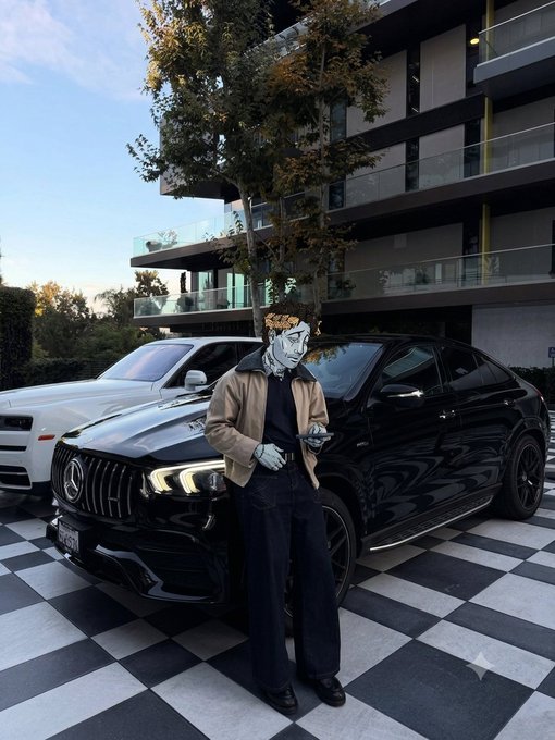 A person wearing a metallic grey face mask and brown jacket stands next to a black Mercedes-Benz SUV in a checkered parking area in front of a modern apartment building.