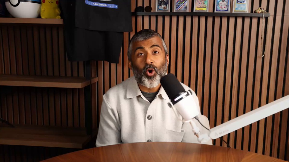 The image features a man sitting at a table with a microphone, wearing a white shirt. He appears to be making a funny face or expression as he speaks into the microphone. The caption of the image reads "Mama mia @Courtyard_io got coins now". This suggests that the man might have been discussing his collection of Pokemon cards during their conversation.