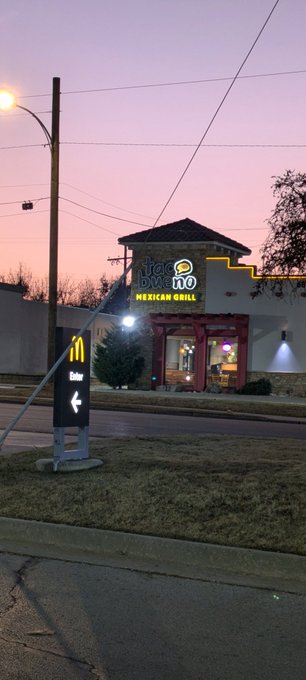 A McDonald's restaurant exterior is shown at dusk with a pink and purple sky; the sign reads 'fresh brewed McCafe MEXICAN GRILL' and an illuminated directional sign shows a McDonald's logo with an arrow pointing left.