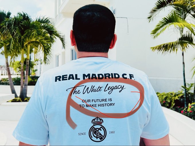 A person wearing a white Real Madrid C.F. soccer jersey that reads "The White Legacy" and "Our future is to make history" with the club crest and "Since 1902" printed on the back.