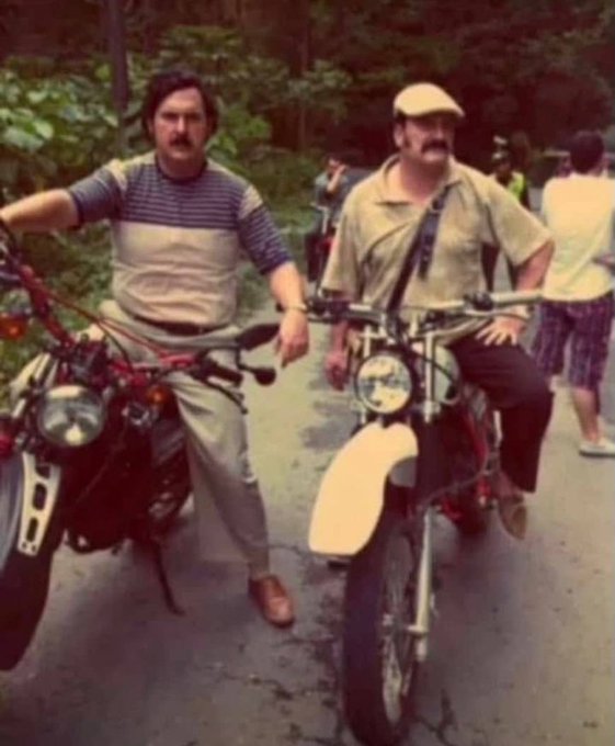 Two men pose on motorcycles on a tree-lined path, embodying the post's message of persistence and camaraderie with the rallying cry "WAGMI" (We're All Gonna Make It) — they're simply there, ready to ride, no quit in sight.