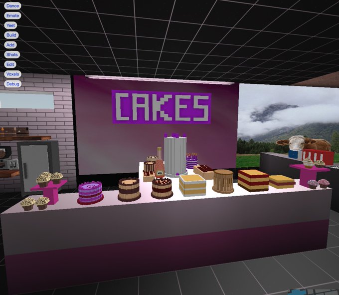 A 3D virtual environment labeled 'CAKES' displays various voxel-style cakes and cupcakes on a counter, with a menu showing options like 'Dance,' 'Emote,' and 'Voxels.'
