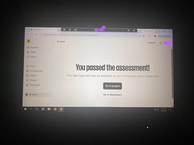 A photo of a computer screen showing a Handshake AI platform page with the message "You passed the assessment!" prominently displayed, supporting the post's claim that the user successfully completed a Handshake assessment task with help.