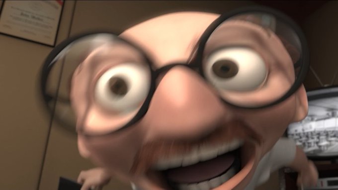 An animated character with large round glasses, wide eyes, and an open-mouthed smile peers closely at the camera in what appears to be a dimly lit room with computer equipment in the background.