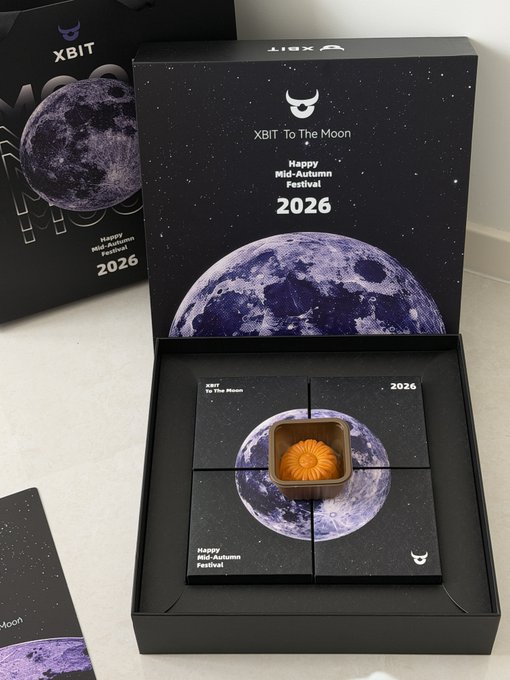 A black gift box labeled 'XBIT To The Moon - Happy Mid-Autumn Festival 2026' contains a single mooncake in its center.