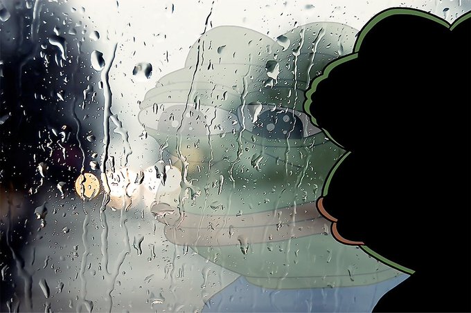 A person with curly black hair presses their face against a rain-streaked window, gazing out at a dark street scene with distant lights reflecting through the droplets. The image metaphorically illustrates the isolation and reflection of perpetual futures traders who feel disconnected from market realities while observing the volatile on-chain profit-and-loss figures of others.