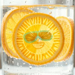 A vibrant orange slice with a cartoon face, submerged in a glass of sparkling water, visually representing the "SUN" cryptocurrency. The imagery playfully connects to the token's name while the post highlights SUN's daily trading volume of $17.955 million, approximately 5.45% of its $329.46 million market cap.