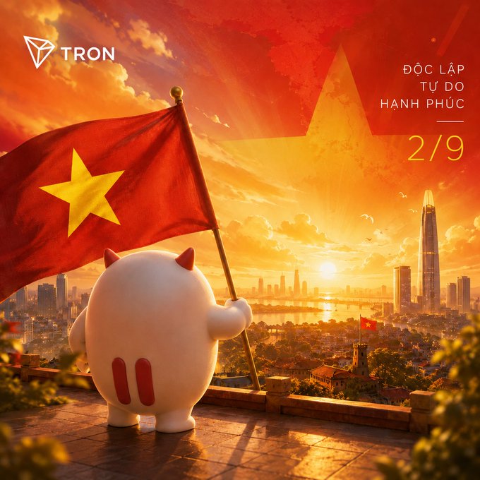 A 3D-rendered white cartoon character with small red devil horns stands on a balcony holding a Vietnamese flag, overlooking a cityscape at sunset, with the TRON logo in the upper left and text reading 'ĐỘC LẬP TỰ DO HẠNH PHÚC' and '2/9' in the upper right.
