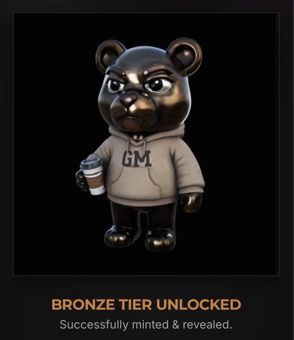 A 3D-rendered bear figurine wearing a gray 'GM' hoodie and holding a coffee cup, with text reading 'BRONZE TIER UNLOCKED' and 'Successfully minted & revealed.'