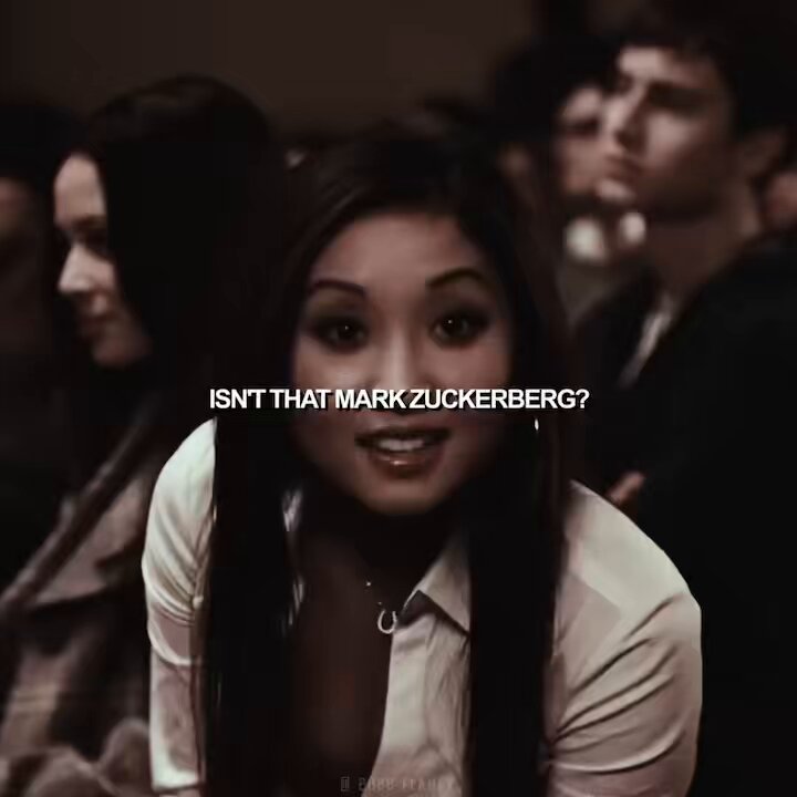 The image features a woman with long hair wearing a white shirt who appears to be smiling at the camera, possibly posing for a photo or video. The caption below her reads "isn't that mark zuckerberg?" which seems to be a reference to a popular internet meme about Mark Zuckerberg and his Facebook status update.