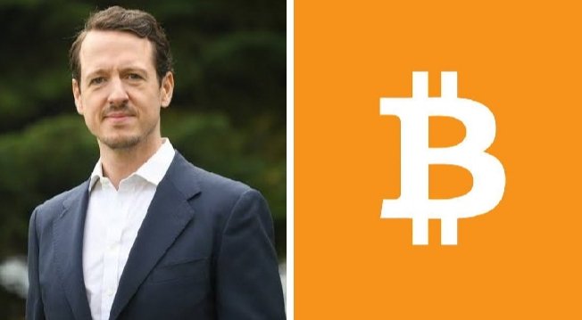 The image features a man wearing a suit standing next to an orange square with the letter "B" on it. The text above the image reads, "Prince Filip of Serbia says Bitcoin adoption is inevitable: 
Every country will eventually adopt Bitcoin." This statement suggests that Bitcoin's widespread adoption is imminent and can be attributed to its increasing popularity among nations worldwide.