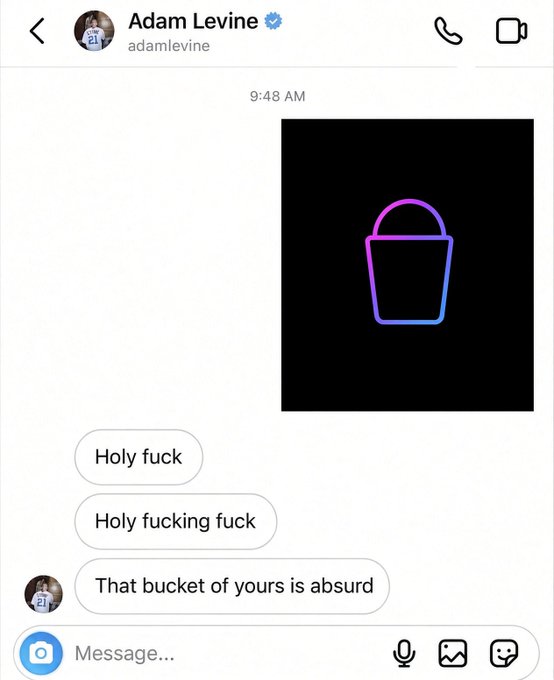 A screenshot of a text message exchange with Adam Levine (verified @adamlevine), where the sender reacts with increasing disbelief ("Holy fuck," "Holy fucking fuck") to a purple-to-blue gradient bucket emoji image, before commenting "That bucket of yours is absurd." The accompanying caption plays on the slang term "$Bucket," treating the ridiculous bucket emoji as a prized flex.