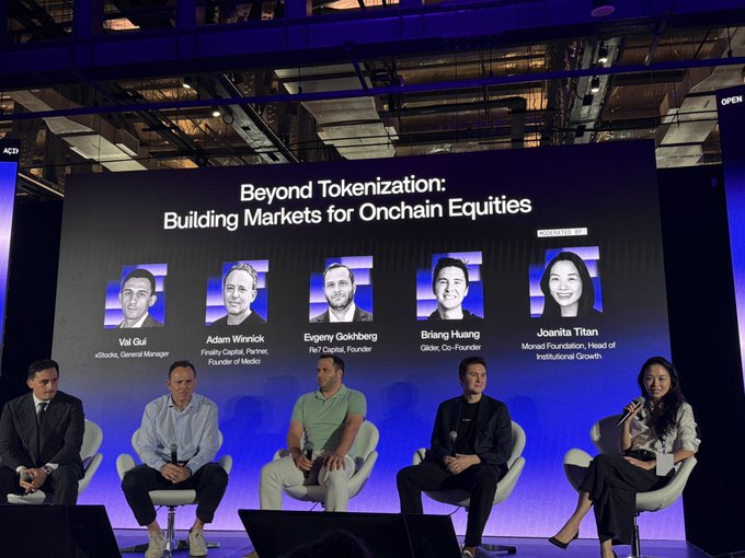 A panel discussion on stage titled 'Beyond Tokenization: Building Markets for Onchain Equities' featuring speakers Vai Oul, Adam Winnick, Evgeny Gokhberg, Briang Huang, and Joanita Titan.