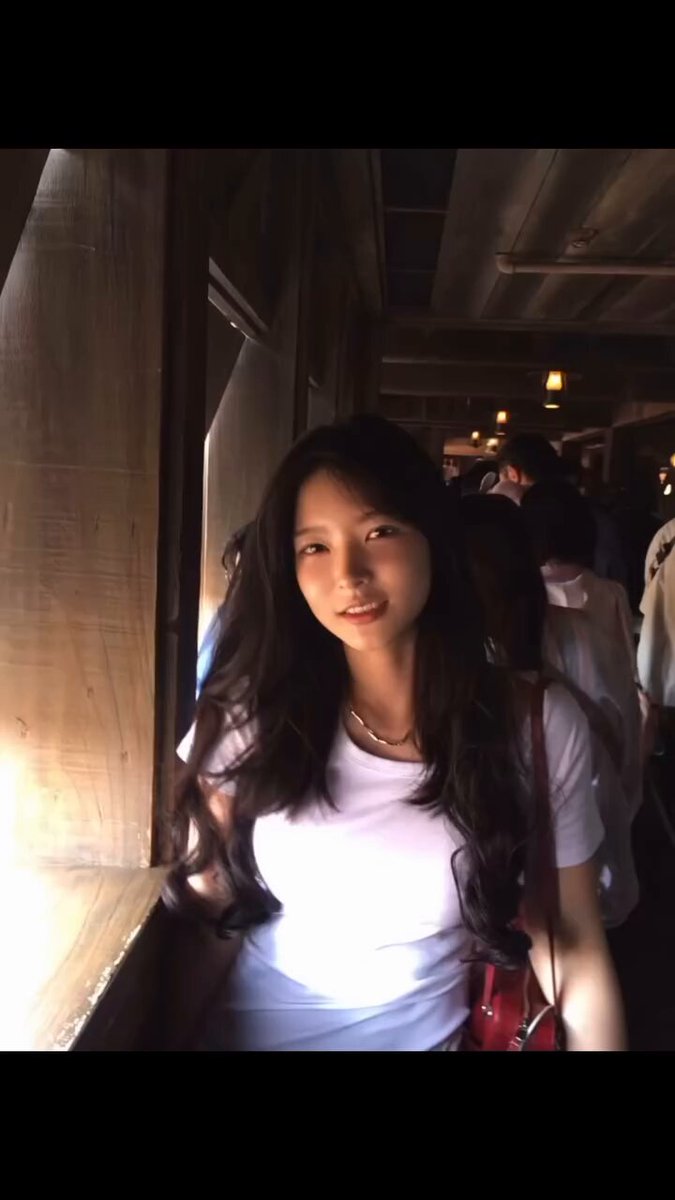 The image features a woman with long hair wearing a white shirt, standing next to a window. She has her head tilted back as if posing for a photo or simply enjoying the view outside. The background of the image shows other people walking by on the street, indicating that she is in an urban setting. The post suggests that it's time to stop focusing on charts and take a look at the world around us, which can be applied to this scene as well.
 
The woman with long hair appears to be the main subject of the image, while other people are present in the background, adding depth and context to the scene. The window provides an interesting perspective for the photo, allowing viewers to see both the woman's face and her surroundings. Overall, this image captures a moment where the viewer can appreciate the beauty of everyday life and the world outside their own personal charts.
