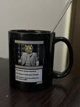 A black coffee mug featuring a 'BREAKING NEWS' style graphic of a cat wearing a suit with text about abandoned cats and tree safety.