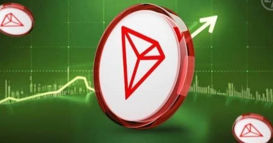 A promotional graphic featuring the red and white TRON (TRX) cryptocurrency coin prominently displayed against a green background with a rising arrow, accompanied by smaller TRON coins in the corners.