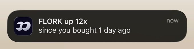 A mobile notification on a dark background from the Wilson app reads "FLORK up 12x since you bought 1 day ago" with a "now" timestamp. The notification highlights a dramatic price surge for the $FLORK token, visually representing the meme coin's massive 12x gain in just 24 hours since purchase.