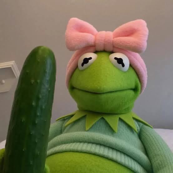 A Kermit the Frog plush toy wearing a pink bow hat sits next to a green pickle, likely serving as a playful visual accompaniment to the announcement of newly added wallets on the 888-society.vercel.app platform.