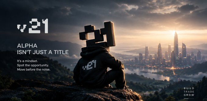 A promotional graphic for 'v.21' featuring a hooded figure with a digital camera for a head looking out over a futuristic city skyline, with text reading 'ALPHA ISN'T JUST A TITLE,' 'It's a mindset. Spot the opportunity. Move before the noise,' and 'BUILD TRADE GROW.'