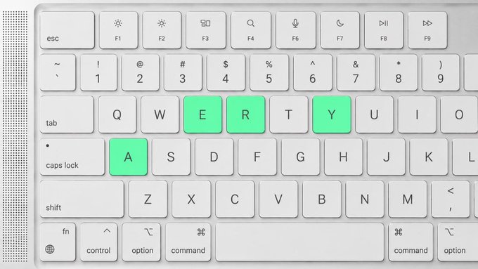 A close-up of a white keyboard with specific keys highlighted in green, spelling out the letters 'A', 'E', 'R', 'Y' across the QWERTY layout.
