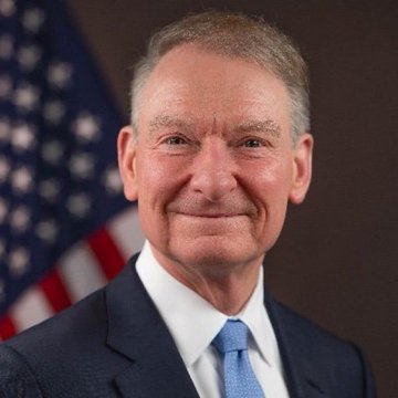 A formal portrait shows SEC Chairman Paul Atkins smiling, wearing a dark suit, white shirt, and light blue tie, with an American flag visible in the background. The image accompanies a post celebrating his commitment to ending "regulation by enforcement" and bringing regulatory clarity to the cryptocurrency industry, particularly benefiting XRP.