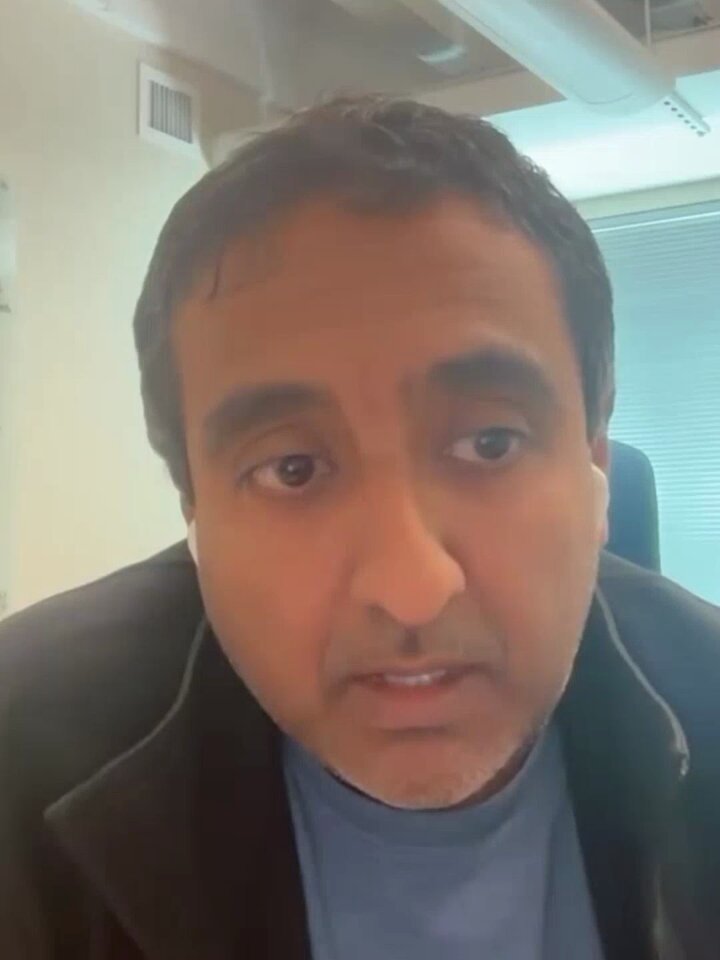 The image features a man wearing a black jacket who appears to be talking or giving advice about cryptocurrency, specifically Bitcoin. The caption of the image suggests that he might be discussing the benefits of using Bitcoin for privacy purposes.