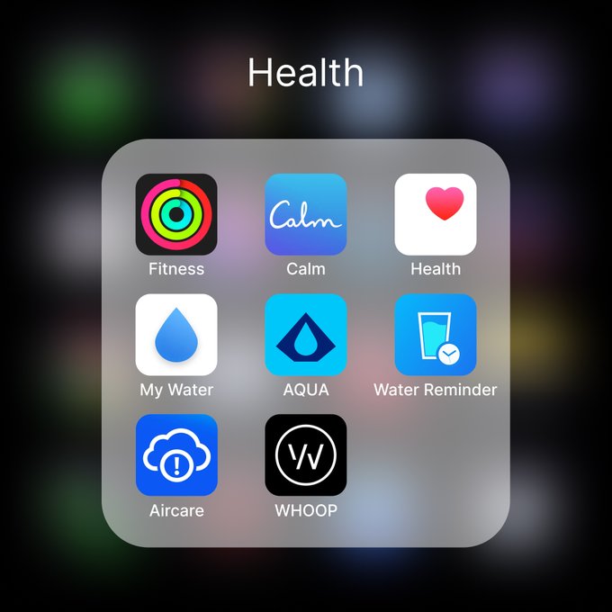 A smartphone “Health” folder displays apps labeled Fitness, Calm, Health, My Water, AQUA, Water Reminder, Aircare, and WHOOP. The image supports the post’s idea of prioritizing a healthy daily routine, though no Bitcoin-related text or symbols are visible.