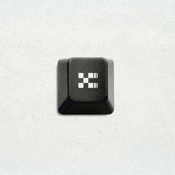 A single black keyboard keycap featuring a pixelated white robot icon rests on a light gray background, visually representing the "tap to switch" prompt as an invitation to engage with agent-focused infrastructure.
