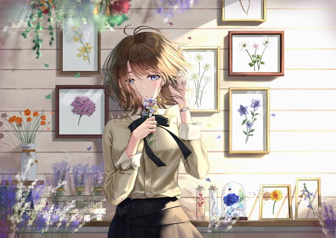 The image features an anime character, possibly a girl or a woman with long hair, standing next to a wall adorned with several framed pictures of flowers. She is holding a flower in her hand, which adds a touch of nature to the scene. The background includes a vase filled with flowers and other decorative items such as potted plants placed on shelves. The image also contains text that reads "Good morning everyone Wishing you a calm and successful day ahead Starting the day by catching up on @NomismaNetwork and keeping tabs on @useTria".
