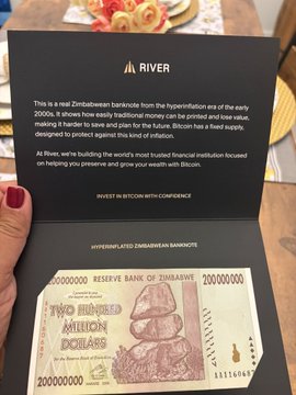 Photo of a person holding a card from 'RIVER' alongside a Zimbabwe two hundred million dollars banknote, with text explaining this is a real Zimbabwean banknote from the hyperinflation era of the early 2000s.