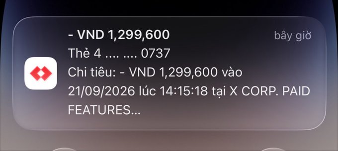 A mobile notification in Vietnamese showing a HSBC bank transaction for -VND 1,299,600 charged to card ending in 0737 at X CORP. PAID FEATURES on 21/09/2026.