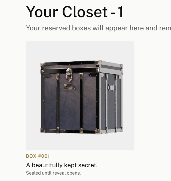 A mobile interface screen titled 'Your Closet - 1' displaying a navy blue steamer trunk labeled 'BOX #001' with the description 'A beautifully kept secret. Sealed until reveal opens.'