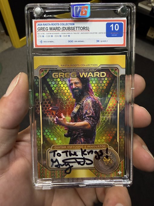 A hand holds a graded "Greg Ward (Dubsetters)" trading card from the 2026 Rasta Roots Collection, autographed "To the King" and featuring a golden lion emblem, sealed in a clear slab with a "10 GEM MINT" label from VerifiedGrades.com. The post celebrates the authenticated collectible as the start of a venture using RFID and blockchain (BSV) verification, tying the high-grade autographed card to his new Smart Ledger Tech project.
