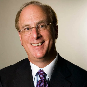A middle-aged man with glasses and a warm smile, wearing a dark suit and patterned tie, poses for a professional headshot against a neutral background. The image likely represents a financial commentator or executive commenting on BlackRock's bullish $128M Bitcoin and $81M Ethereum purchases, signaling smart money's confidence in crypto.