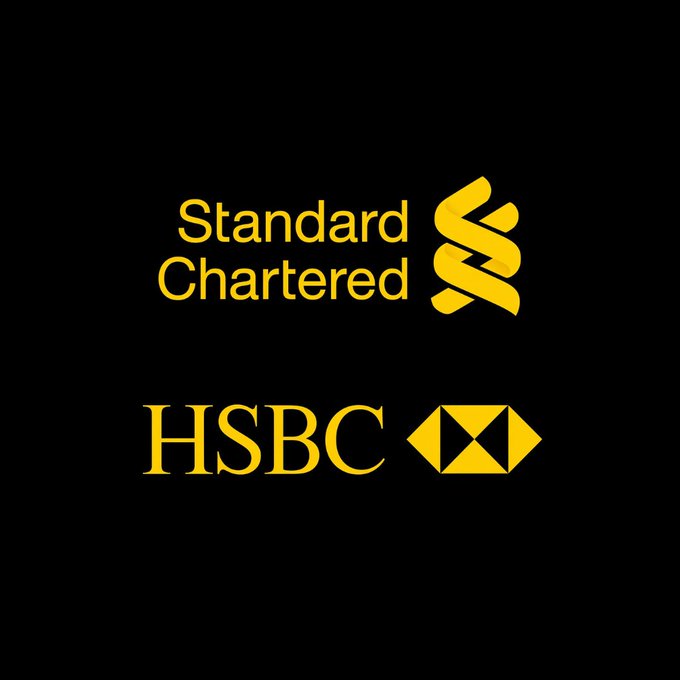 The image displays the yellow logos of Standard Chartered and HSBC on a black background, representing the two banking giants mentioned in the announcement about their landmark live tokenized deposit transaction on Swift's blockchain ledger.