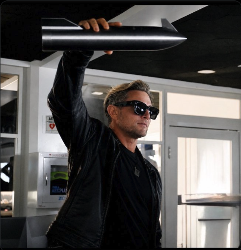 A man with sunglasses and a black leather jacket triumphantly holds a large rocket-shaped object above his head in a modern office setting, appearing to celebrate a successful launch. The rocket symbolism visually reinforces the post's message about rapid, explosive growth, as the speaker boasts about closing two major deals in just 47 days.