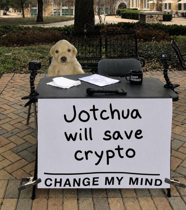 A 'Change My Mind' meme featuring a golden retriever at a table with cameras and a 'Duder Crowder' mug, with the sign reading 'Jotchua will save crypto'.